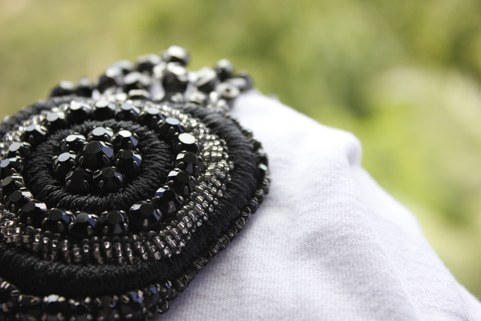 Black spiral hand beaded brooch with crystals and silver beads by Imroz Fashions